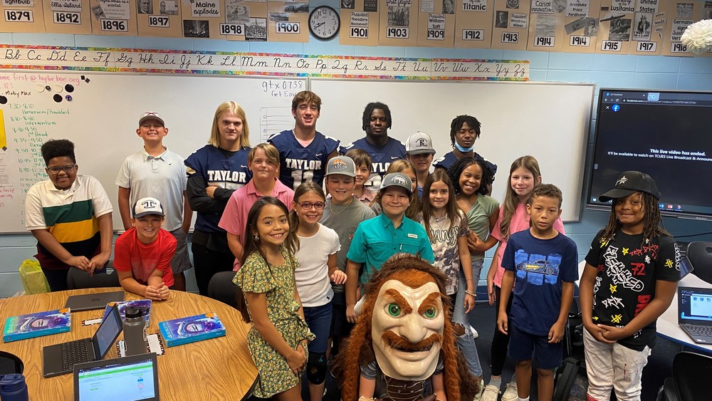 TCHS Football Players Visit Upper Elementary